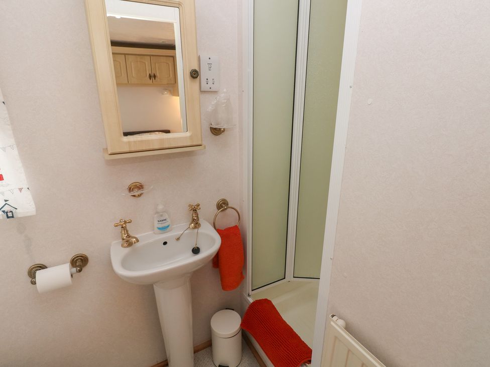 A bathroom with a sink and shower at Static Caravan