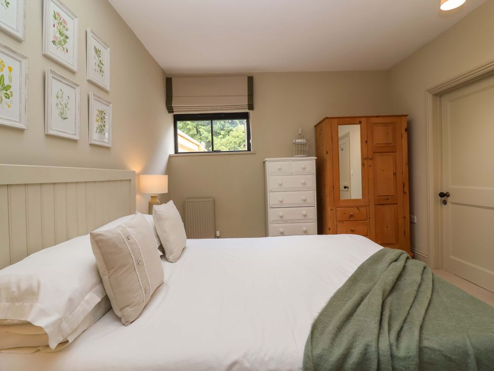 A bedroom with a bed and furniture at The Annex in Burford