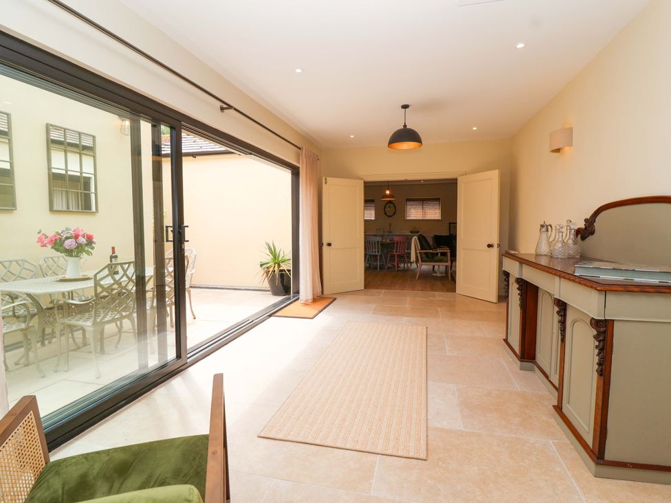 A room with a view of a dining area and outdoor seating at The Annex in Burford