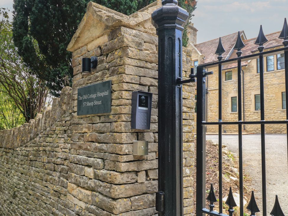 A gate with intercom and nameplate at The Old Cottage Hospital Annexe in Burford