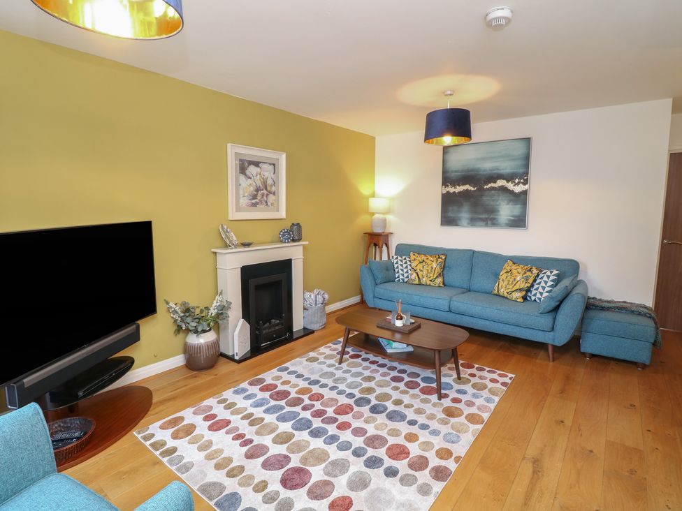 A living room with a television and sofa at No 39 Ashbourne