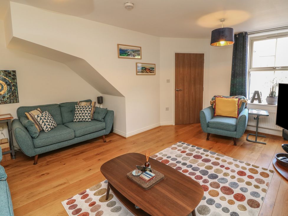 A living room with a sofa and armchair at No 39 Ashbourne