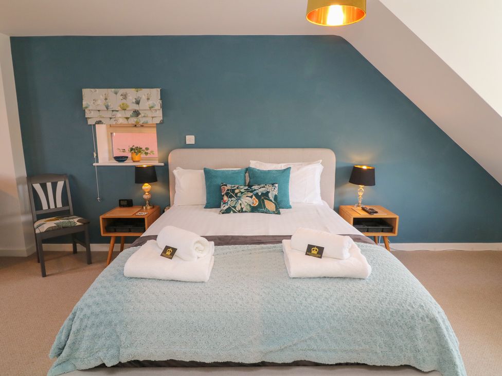 A bedroom with a bed and nightstand at No 39 in Ashbourne