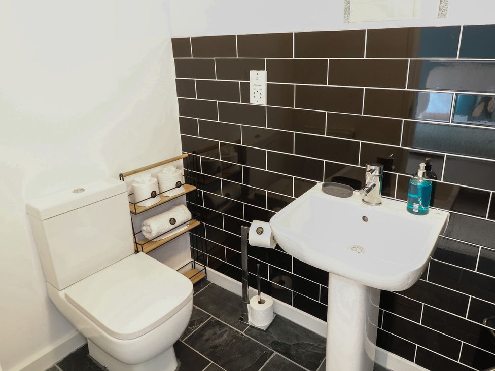 A bathroom with a toilet and sink at No 39 Ashbourne