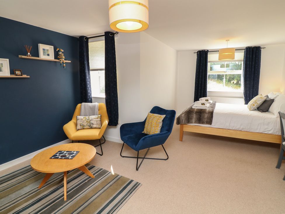 A bedroom with a bed and chairs at No 39 Ashbourne