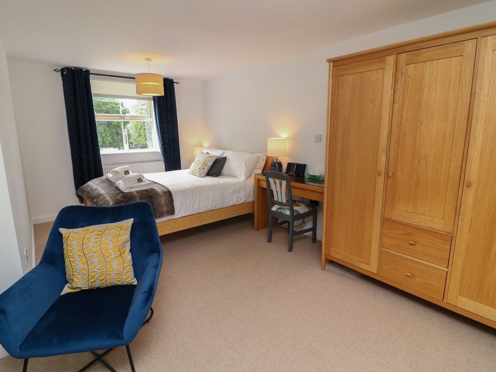 A bedroom with a bed and a desk at No 39 in Ashbourne