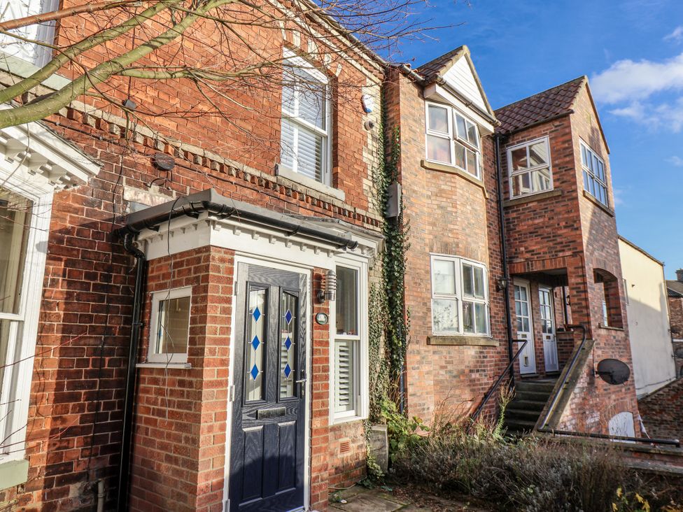 A brick house with a front door and multiple windows at 1 Castle Terrace