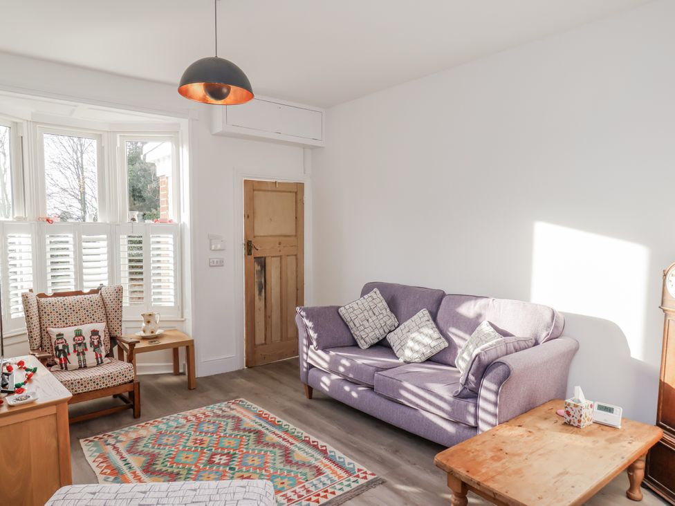 A living room with a sofa and armchair at 1 Castle Terrace