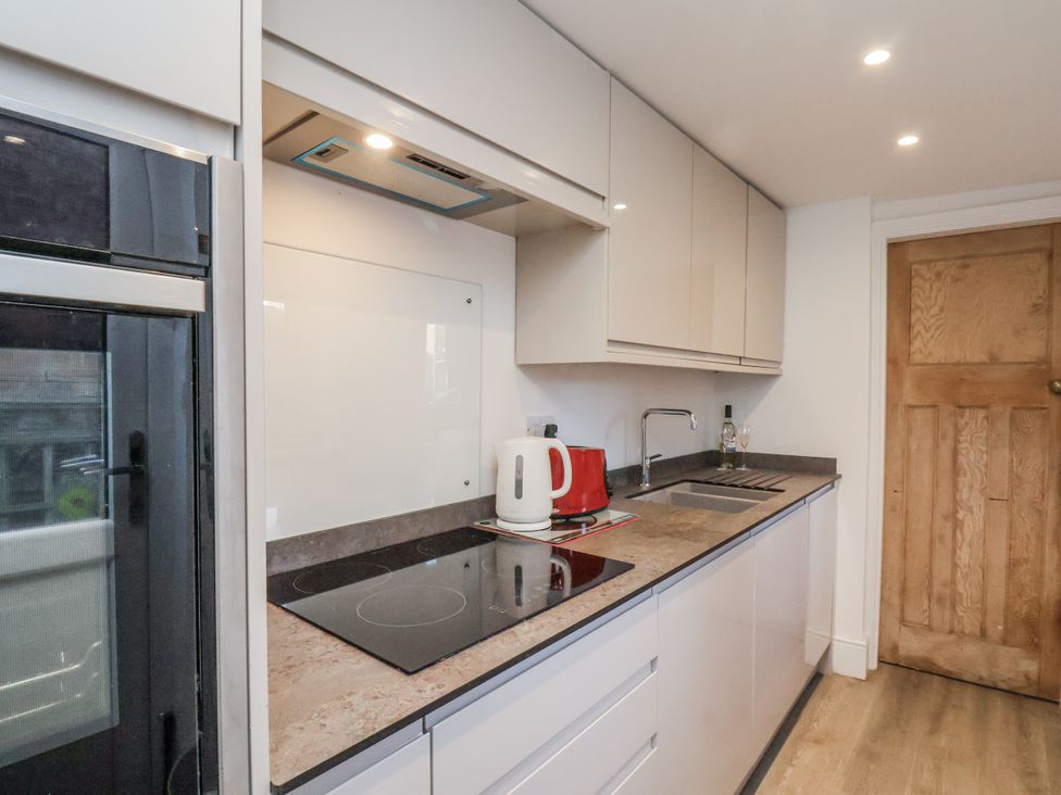 A kitchen with a kettle and cooking hob at 1 Castle Terrace 