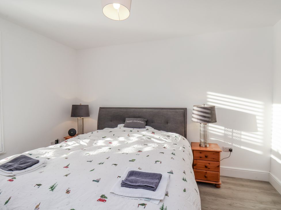 A bedroom with a bed and bedside table at 1 Castle Terrace