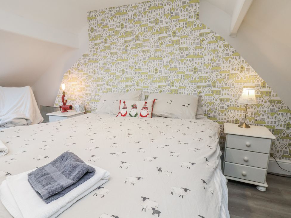 A bedroom with a bed and nightstand at 1 Castle Terrace