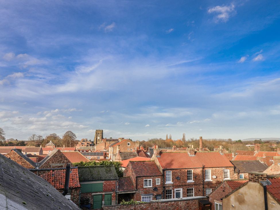 A view of rooftops and buildings under a blue sky at 1 Castle Terrace