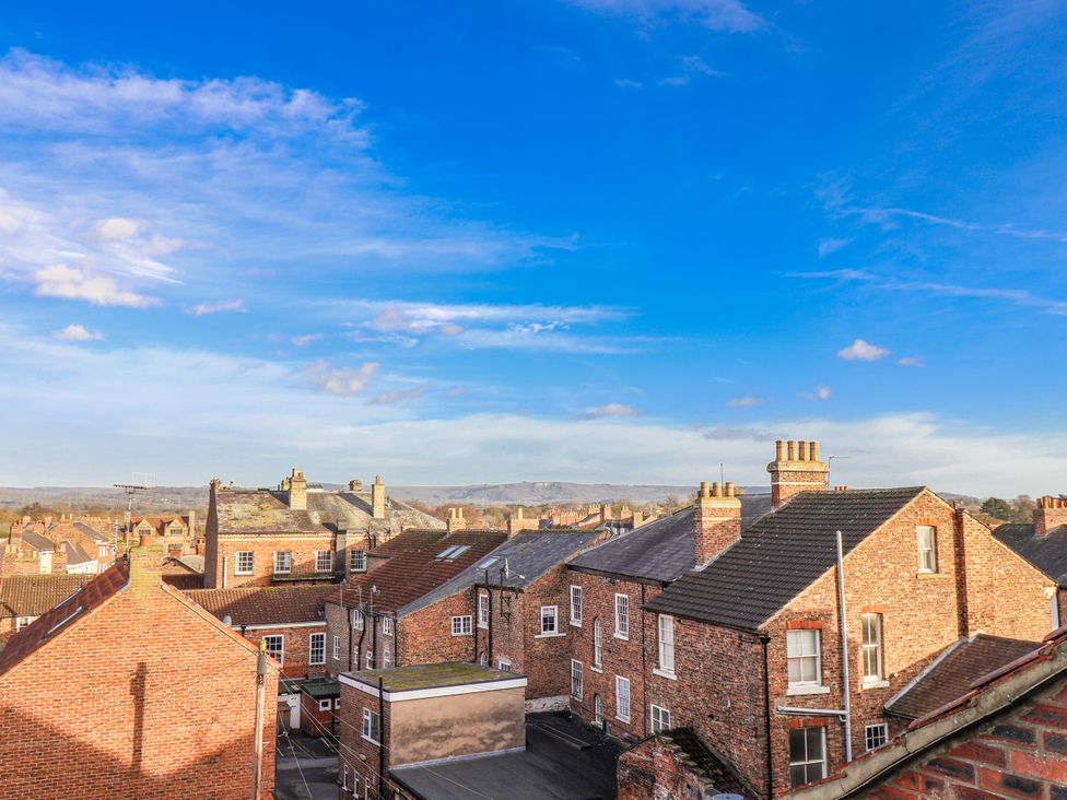 A view of rooftops and chimneys under a blue sky at 1 Castle Terrace