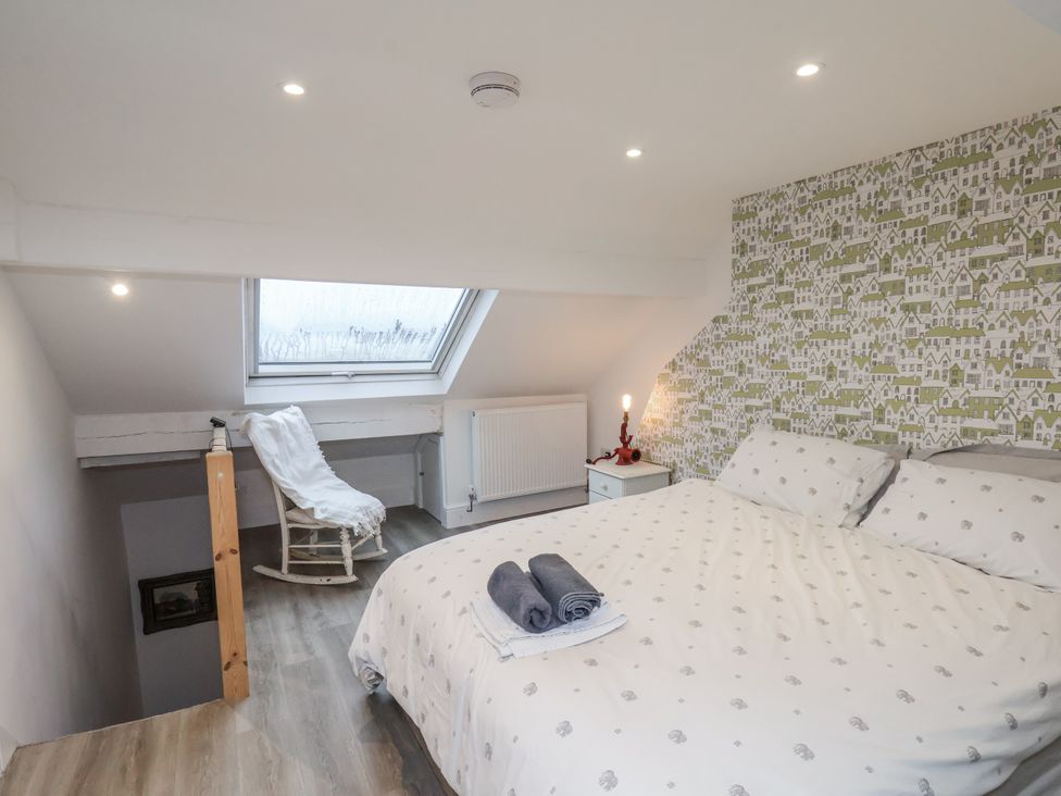 A bedroom with a bed and chair at 1 Castle Terrace in Thirsk