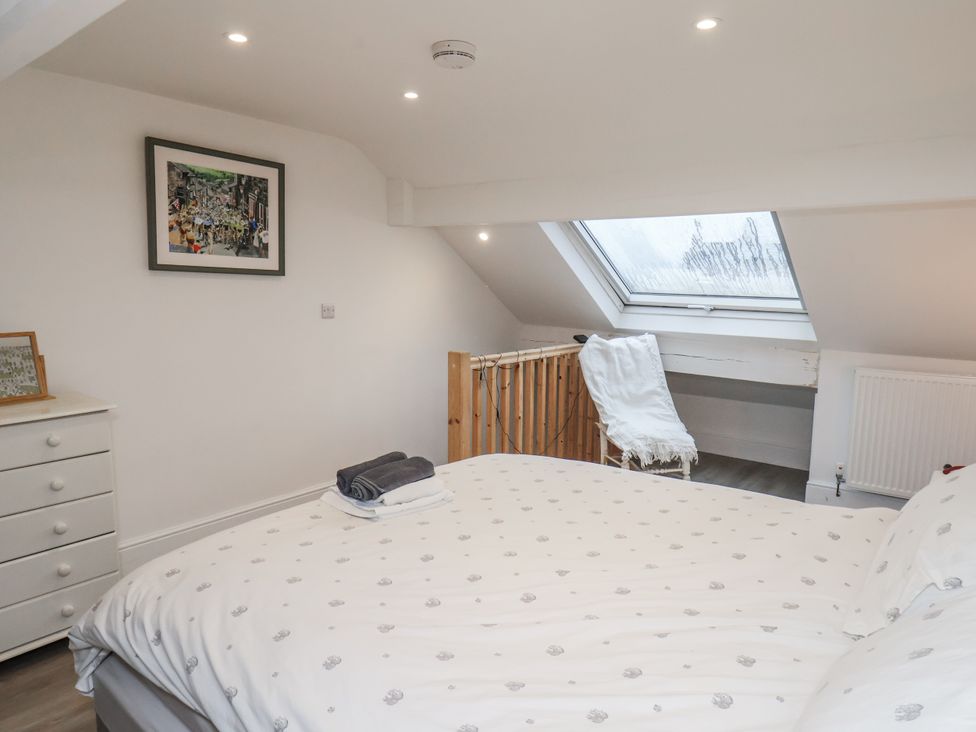 A bedroom with a bed and a dressing table at 1 Castle Terrace in Thirsk