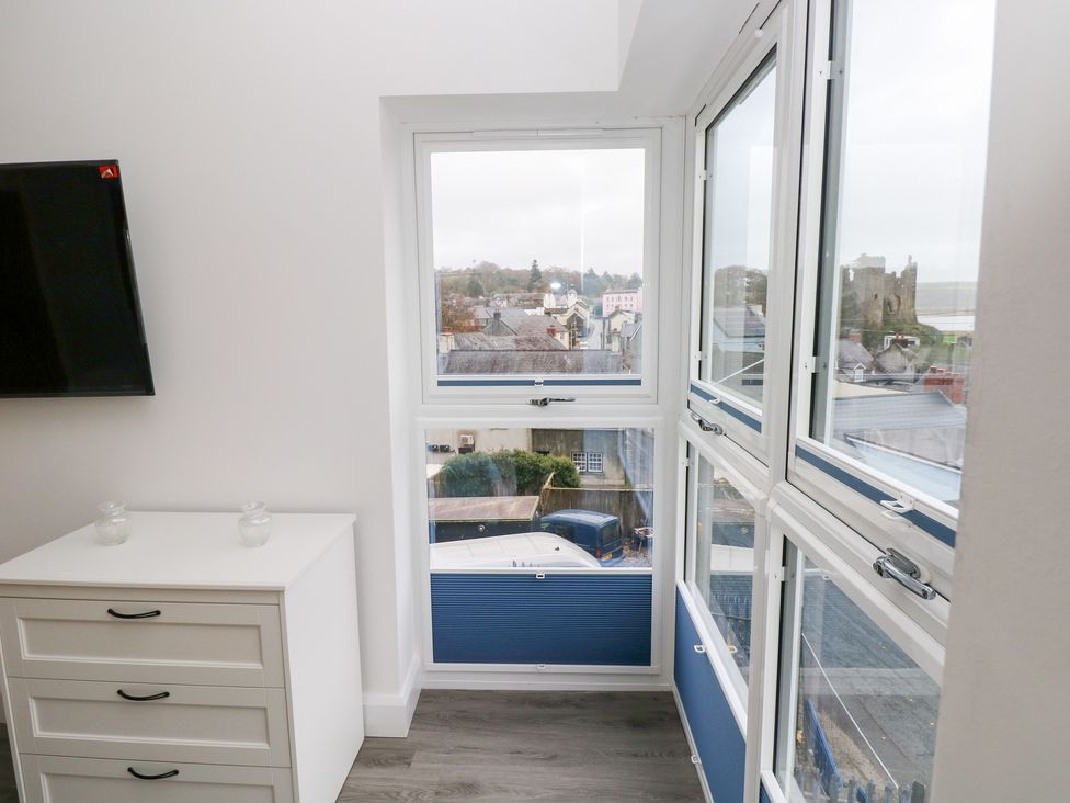 A room with a window and television at Cottage 1 in Laugharne