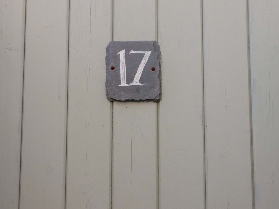 A number sign 17 on a wooden wall at Tradewinds in Newquay
