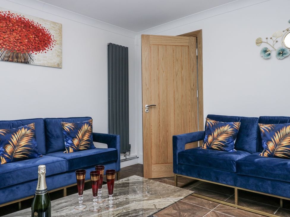 A living room with blue sofas and a table at Aspen Boutique in 