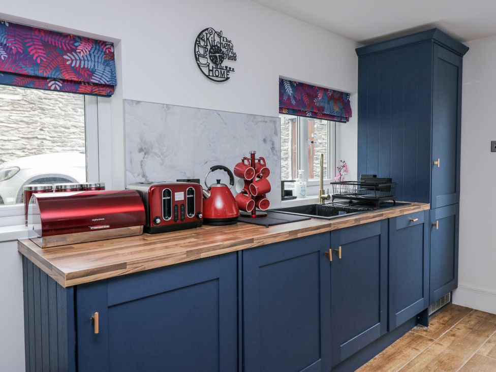 A kitchen with cabinets, a sink, and appliances at Aspen Boutique