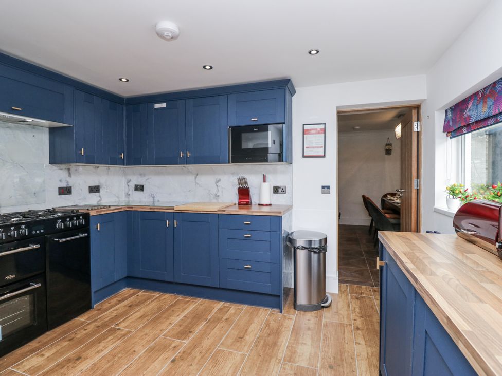 A kitchen with blue cabinets and stainless steel appliances at Aspen Boutique
