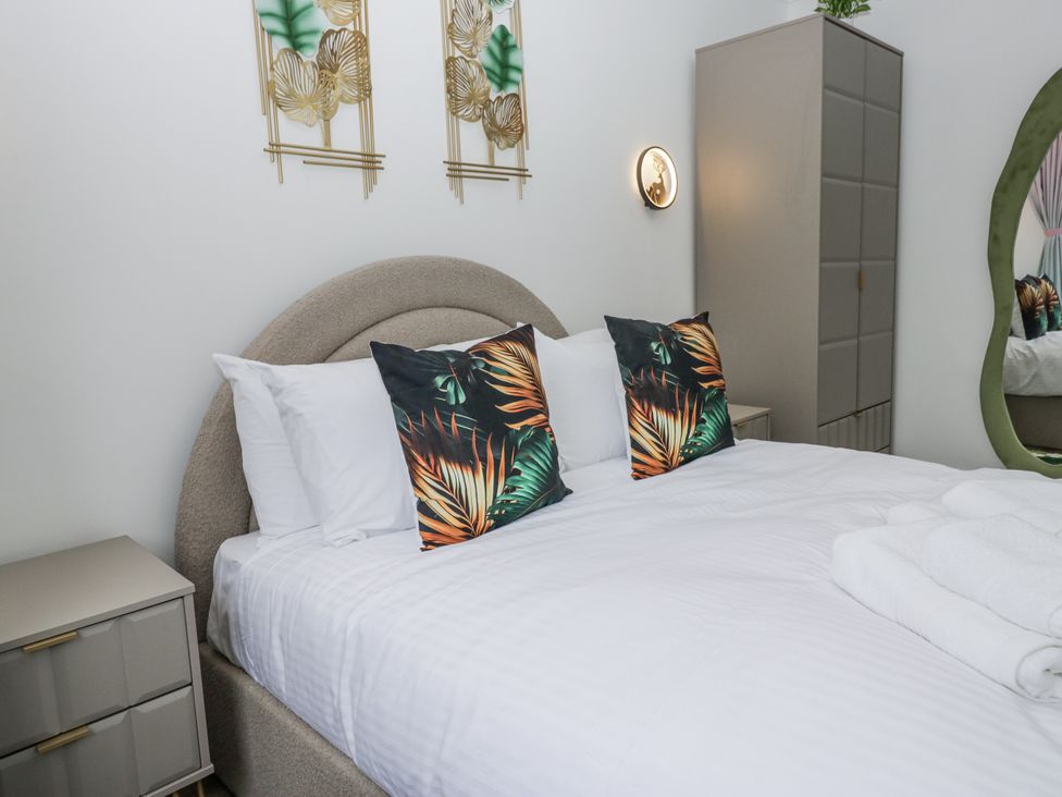 A bedroom with a bed and decorative pillows at Aspen Boutique