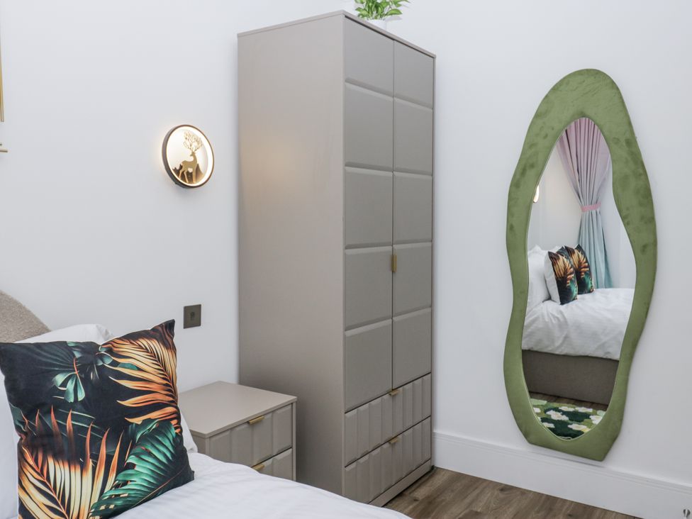 A bedroom with a bed and wardrobe at Aspen Boutique