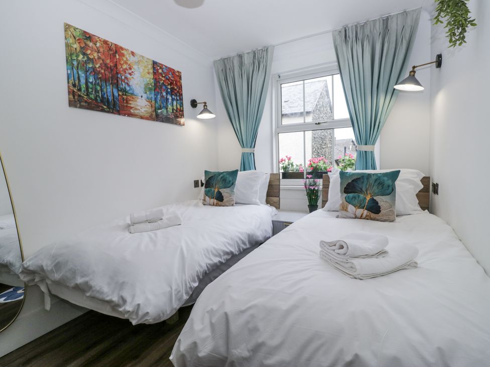 A bedroom with two single beds and a window at Aspen Boutique in 