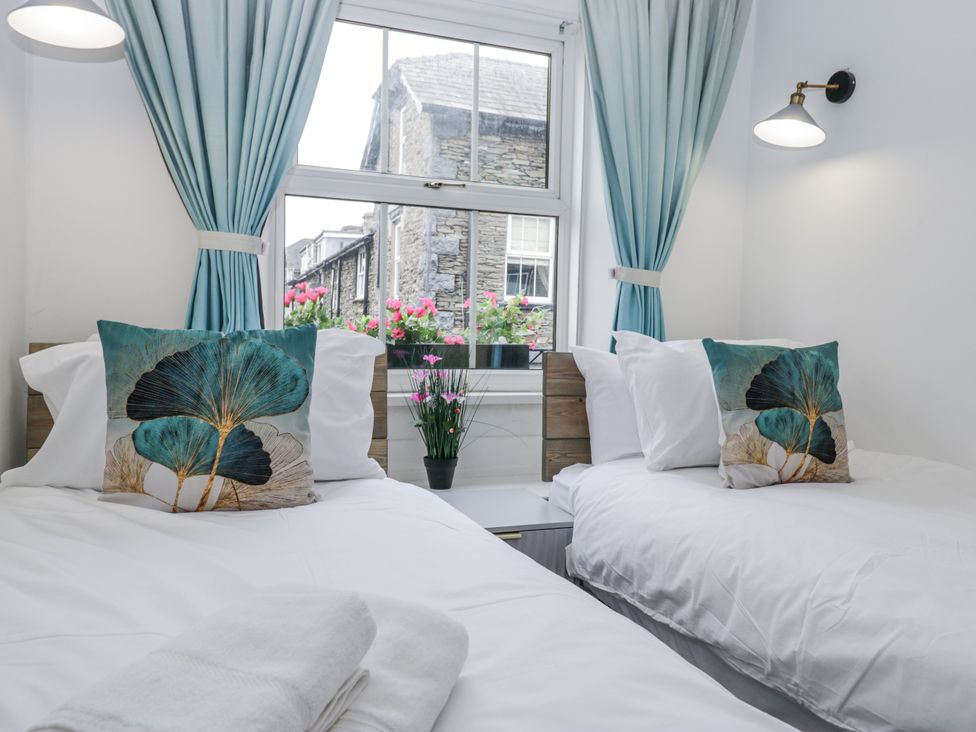 A bedroom with two beds and a window at Aspen Boutique
