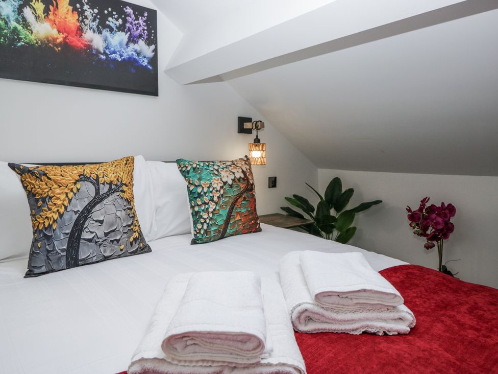A bedroom with a bed adorned with pillows and towels at Aspen Boutique