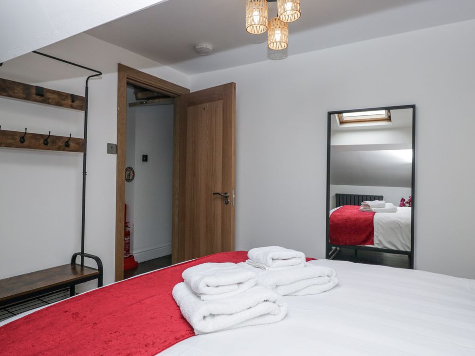 A bedroom with towels on a bed at Aspen Boutique