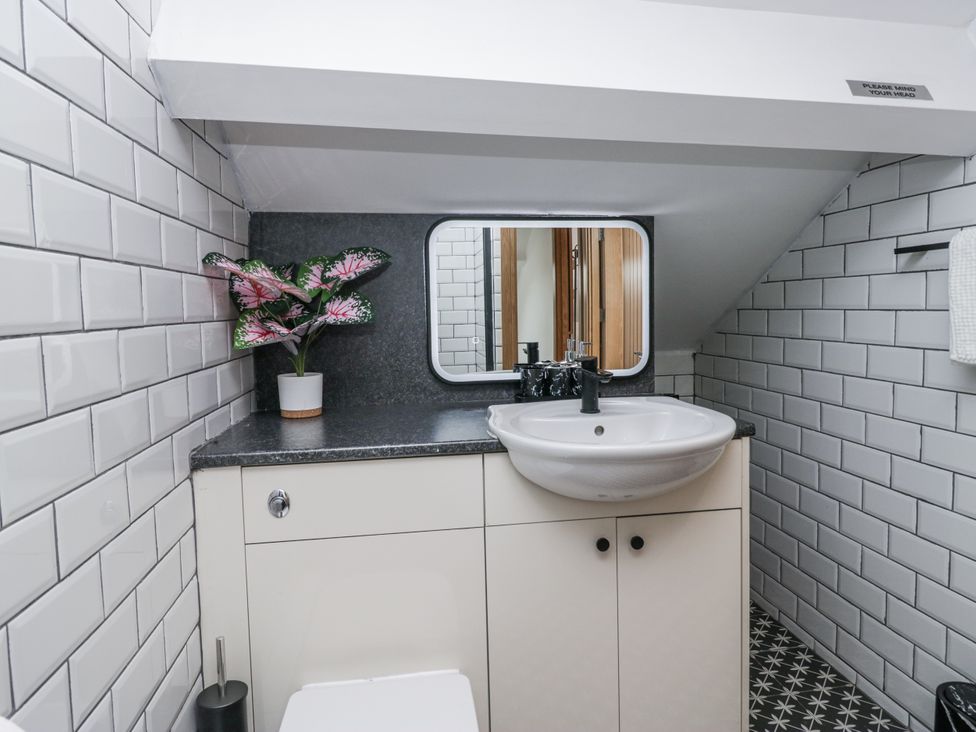 A bathroom with sink and mirror at Aspen Boutique