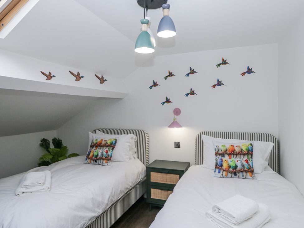 A bedroom with two beds and colorful wall art at Aspen Boutique in 