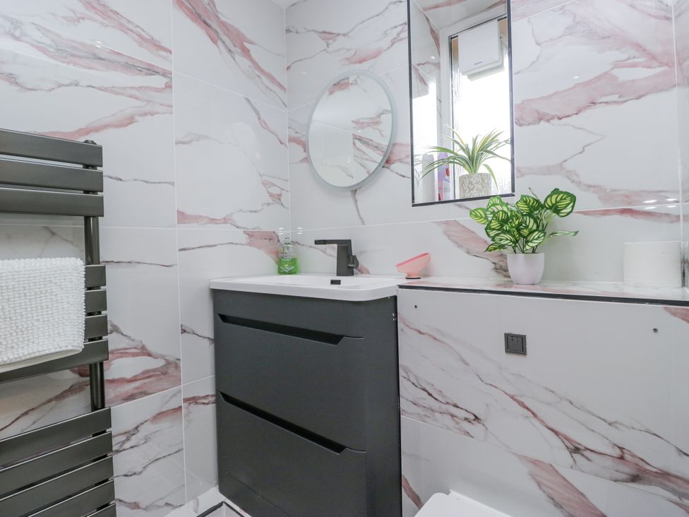 A bathroom with a sink and mirror at Aspen Boutique