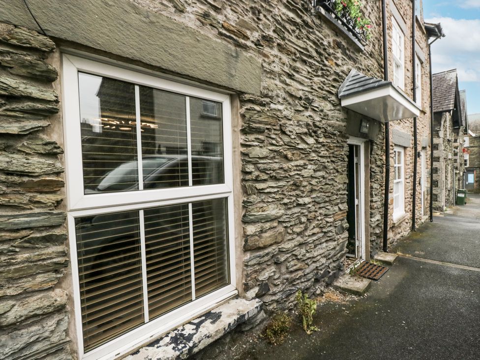 A stone building with a window and door at Aspen Boutique