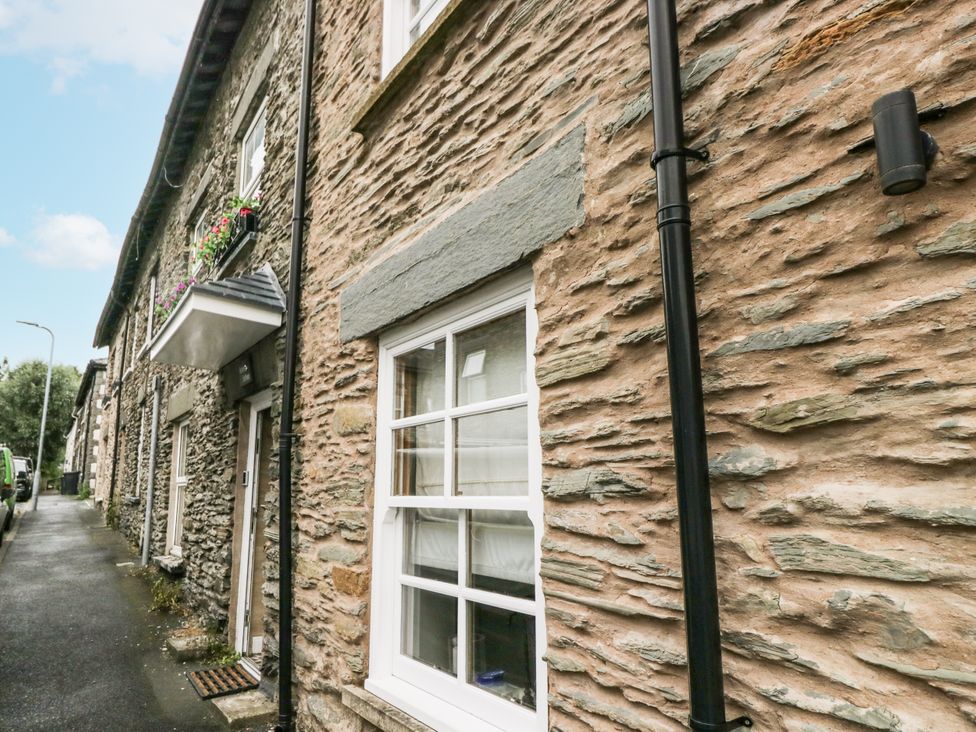 An exterior view of a stone house with windows and flower boxes at Aspen Boutique