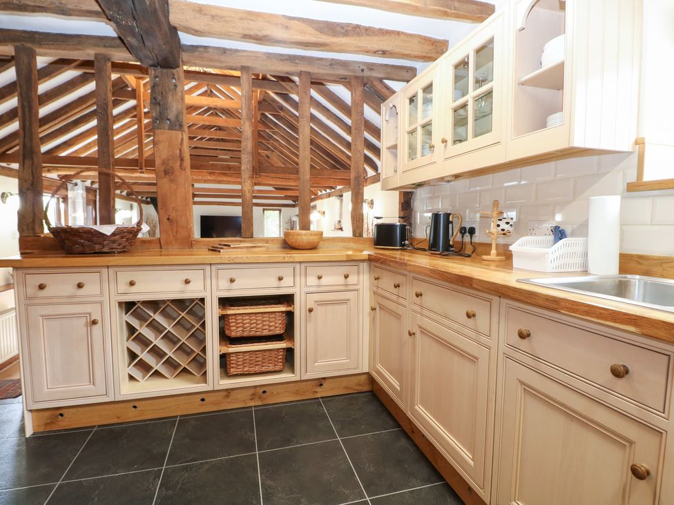 A kitchen with cabinets and a sink at WEST LODGE Ashford