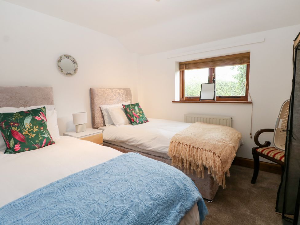 A bedroom with two beds and a window at WEST LODGE Ashford