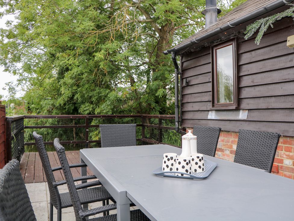 An outdoor dining table with chairs at WEST LODGE in Ashford