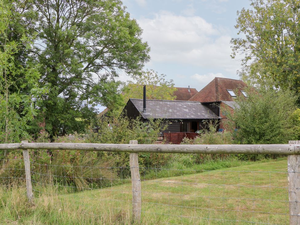 A house surrounded by trees and grass at WEST LODGE in Ashford