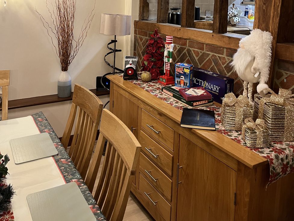 A dining room with a sideboard and decorative items at WEST LODGE in Kingsnorth