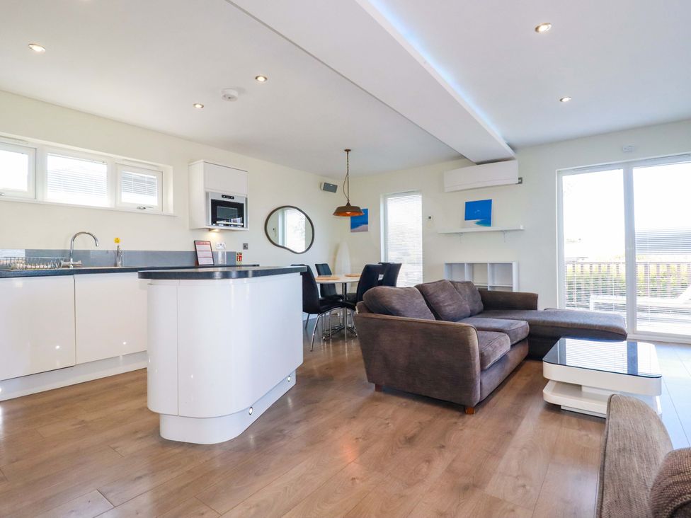 A kitchen with a sofa and dining area at Gwel An Mor Portreath