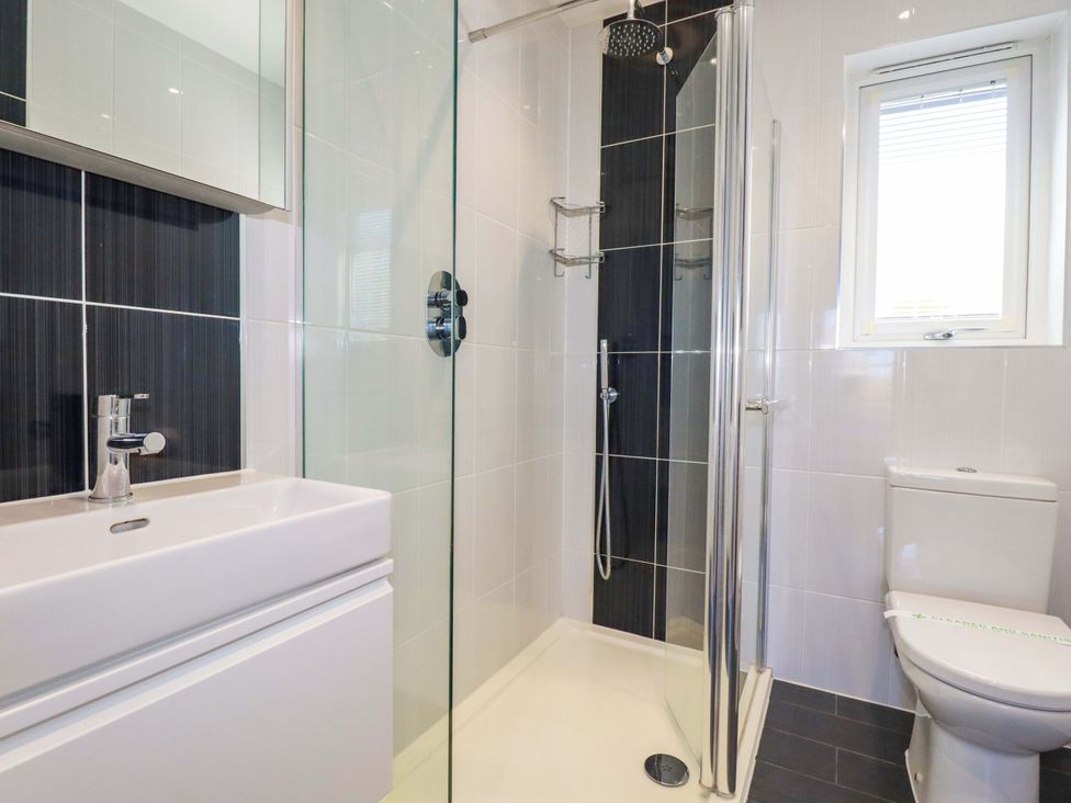 A bathroom with a shower, sink, and toilet at Gwel An Mor in Portreath