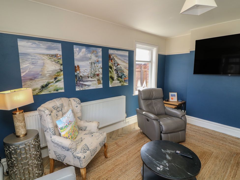 A living room with armchair and television at 54 George Street in Mablethorpe