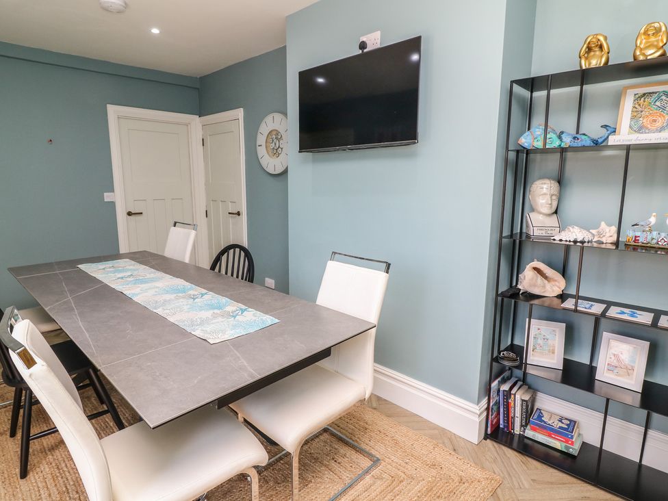 A dining room with a table and chairs at 54 George Street Mablethorpe