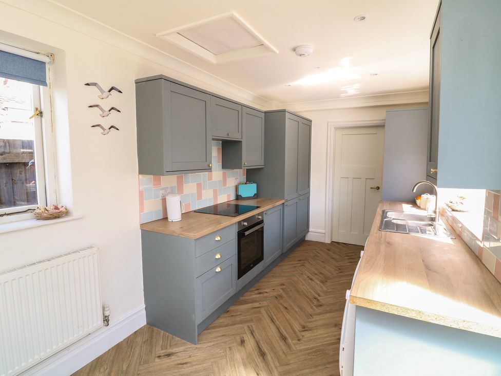 A kitchen with cabinets and countertop at 54 George Street in Mablethorpe