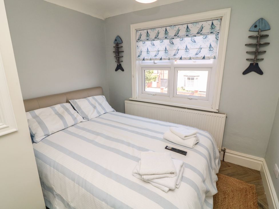 A bedroom with a bed and window at 54 George Street Mablethorpe