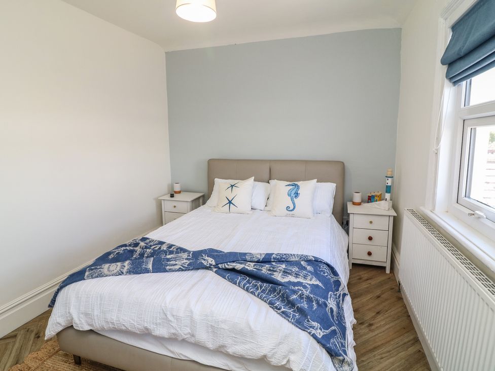 A bedroom with a bed and nightstands at 54 George Street in Mablethorpe