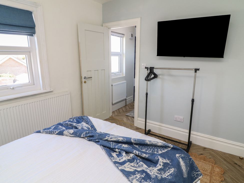A bedroom with a bed and television at 54 George Street in Mablethorpe