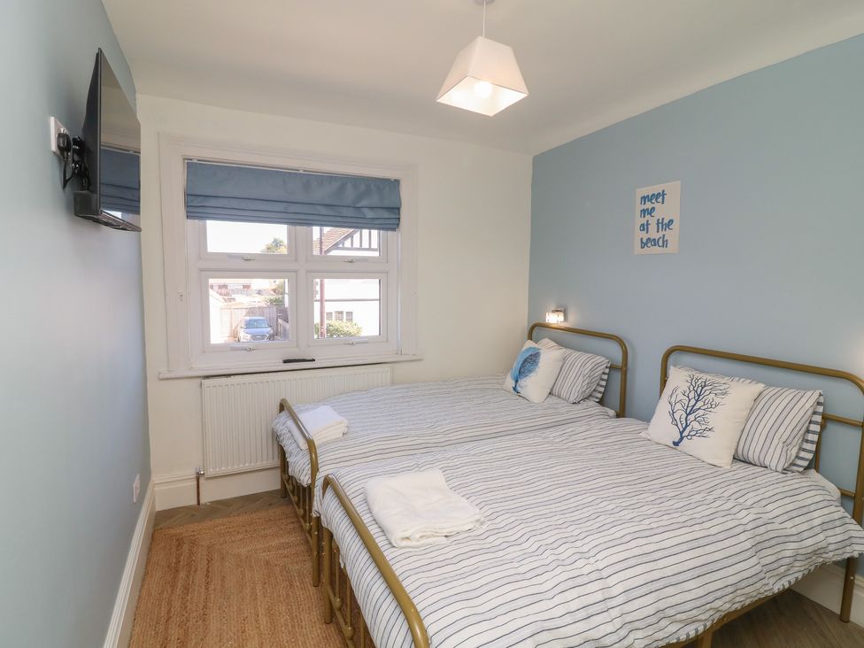 A bedroom with twin beds and a television at 54 George Street Mablethorpe