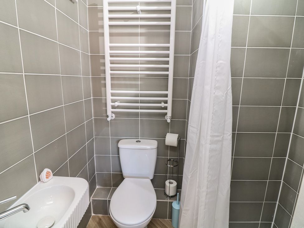 A bathroom with a toilet and sink at 54 George Street Mablethorpe